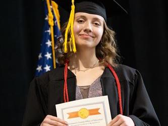 Graduate showing off certificate
