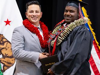 futures principal posing with graduating student