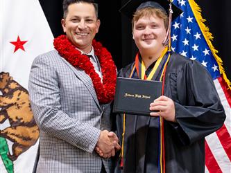 futures principal posing with graduating student