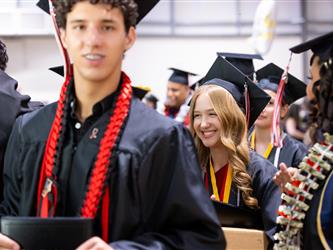 futures principal shaking hands with graduating student