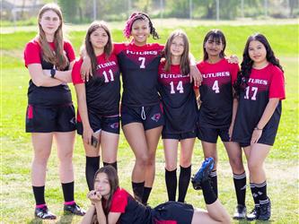 Girls soccer teammates posing together