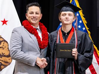 futures principal posing with graduating student