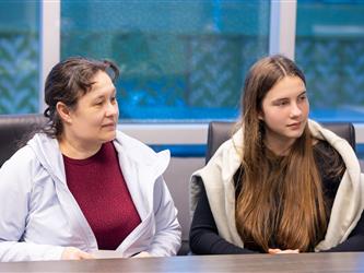 two students sitting next to each other 