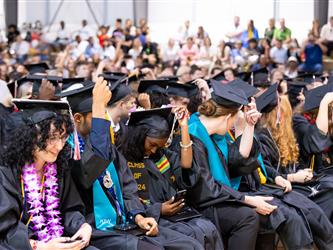 futures principal shaking hands with graduating student