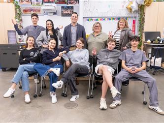 students posing on chairs