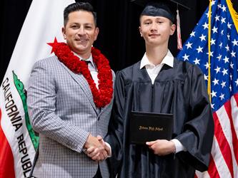 futures principal posing with graduating student