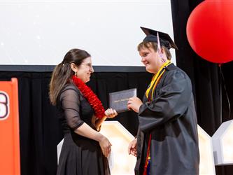 futures principal posing with graduating student