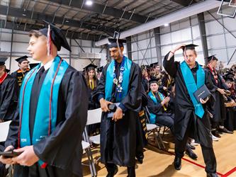 futures principal shaking hands with graduating student