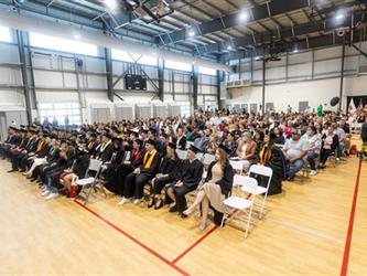 Gym full of families seated for graduation